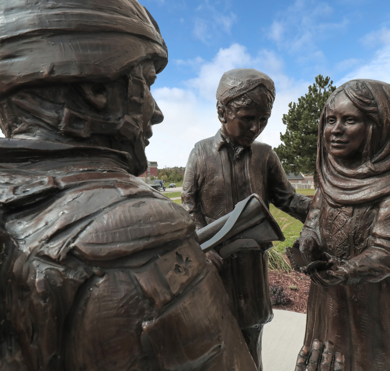 Sculpture of a soldier and two children